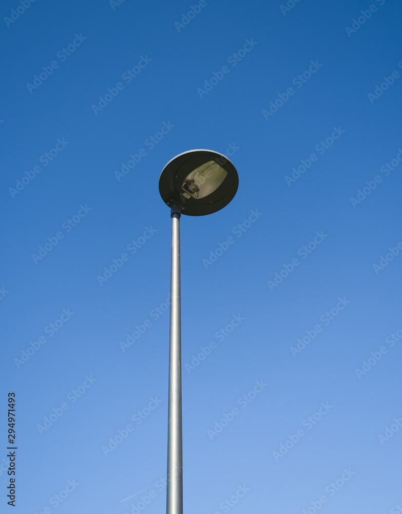 Modern street lamp in the blue sky. Theme of urban comfortable environment and infrastructure