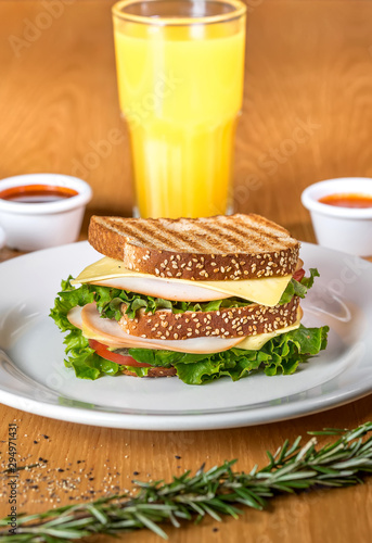 Ham sandwich and orange juice snack 