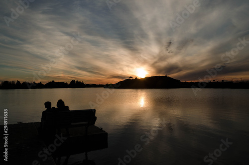  couple sitting watching a beautiful sunset