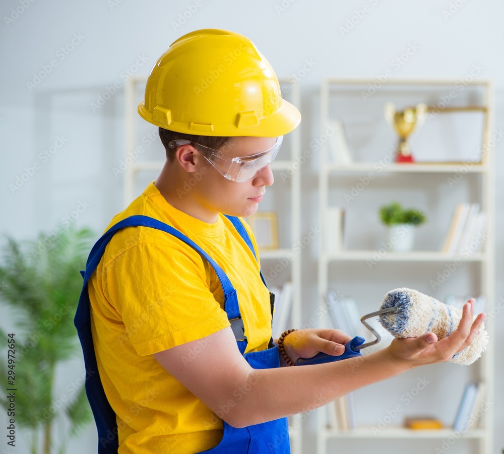 Painter working at home in refurbishment project Painter working at home in refurbishment project