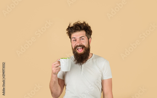 Awaking. Bearded man with cup of coffee. Tired guy hold coffee. Man hold cup with coffee. Coffee. Morning refreshment. Morning routine. Wake up.