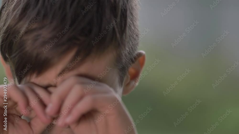 boy looks into the camera and crying, close up, slow motion boy looks into the camera and crying, close up, slow motion