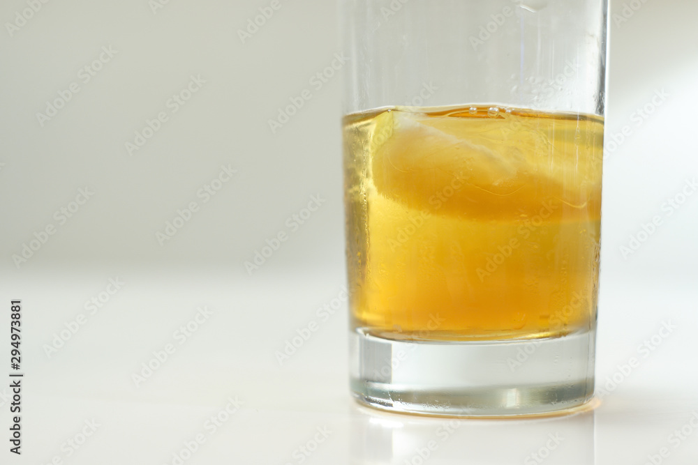 Scotch in a glass on a white table top and background Scotch in a glass on a white table top and background