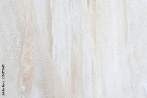 Wallpaper Mural Hanging grungy gauze fabric against white cloth background in shallow depth of field with subtle shadows light and shapes as blurred texture and design element as part of Halloween themed images Torontodigital.ca