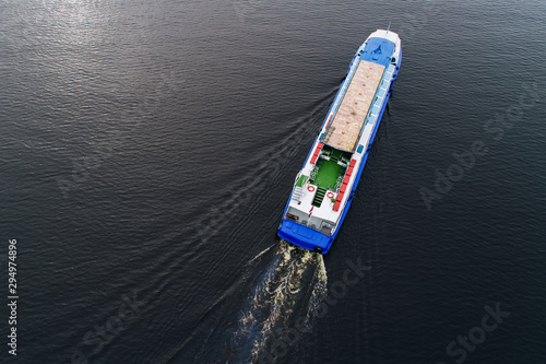 Tourist ship travels down the river Daugava in Riga, Latvia. Captured from above with a drone.
