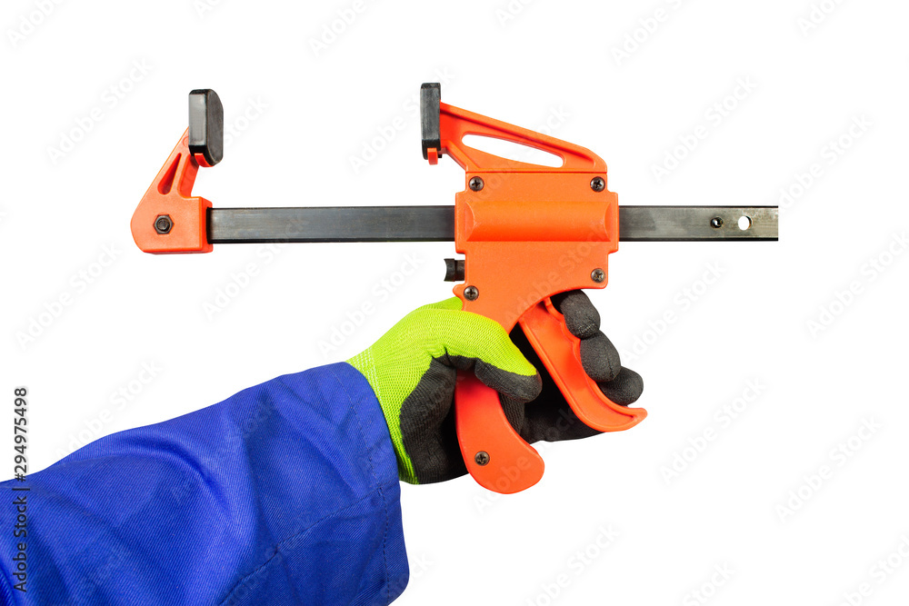 Isolated worker hand in gloves holding one-handed bar clamp. Isolated worker hand in gloves holding one-handed bar clamp.