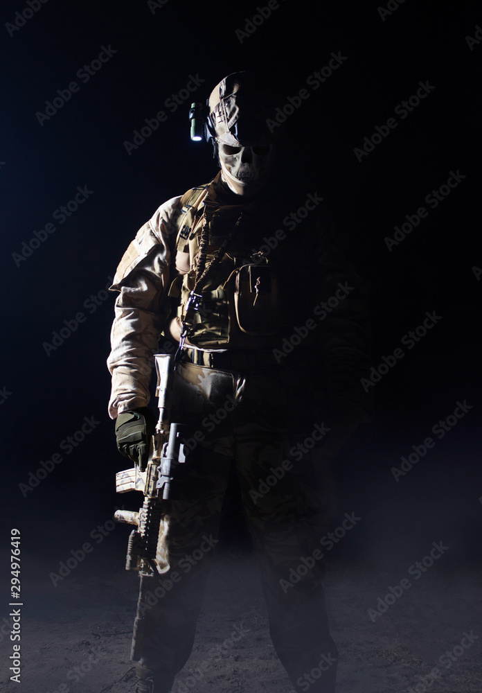 Scary desert skeleton ghost soldier standing with rifle on dark background.