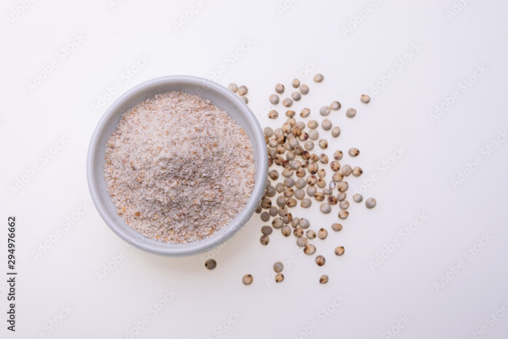 Uncooked raw Sorghum flour (also known as sorgo) in a white bowl, isolated on white background Uncooked raw Sorghum flour (also known as sorgo) in a white bowl, isolated on white background