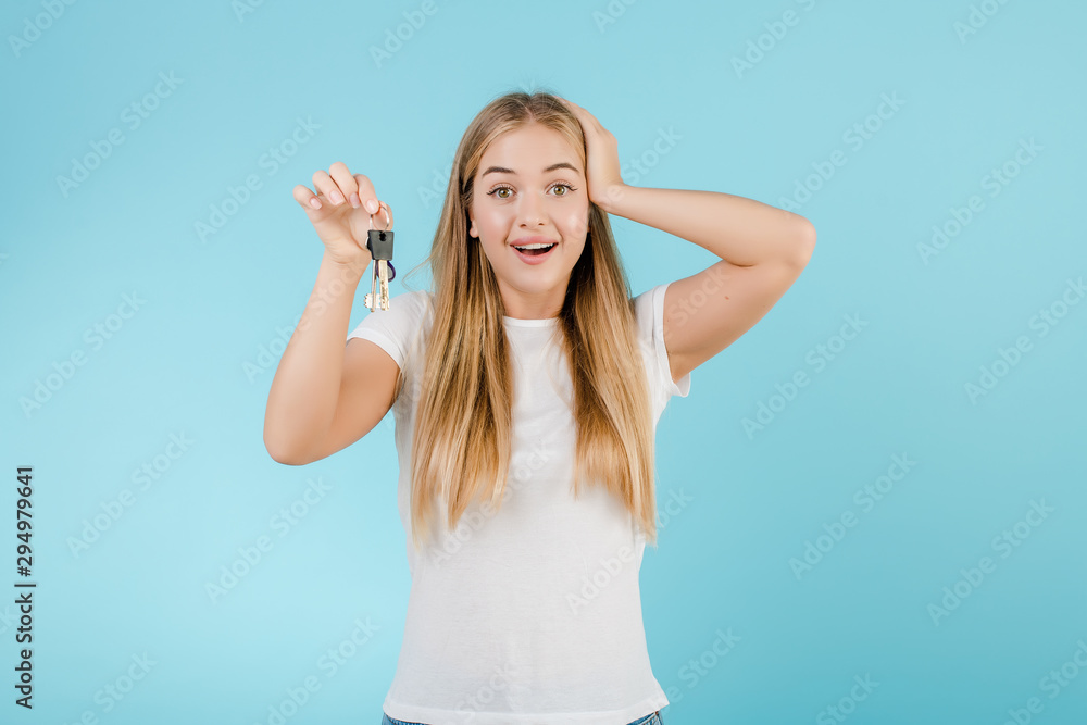 happy smiling blonde woman with keys from apartment isolated over blue happy smiling blonde woman with keys from apartment isolated over blue