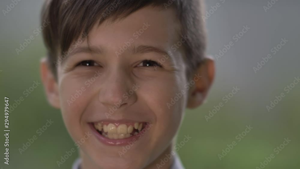 portrait of a funny boy laughing outdoors, close up portrait of a funny boy laughing outdoors, close up