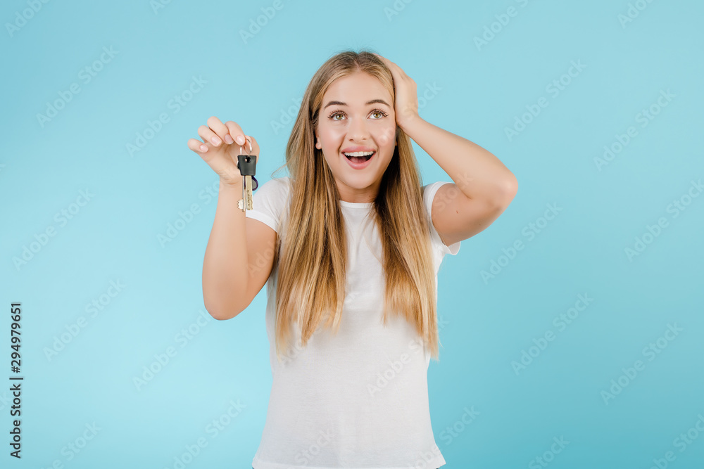 happy smiling blonde woman with keys from apartment isolated over blue happy smiling blonde woman with keys from apartment isolated over blue