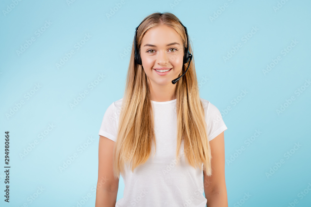 friendly smiling blonde call center operator with headset isolated over blue friendly smiling blonde call center operator with headset isolated over blue