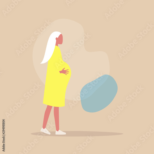 A profile full view of young pregnant blonde woman touching her belly