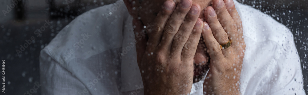 panoramic shot of crying upset man with ring on finger panoramic shot of crying upset man with ring on finger