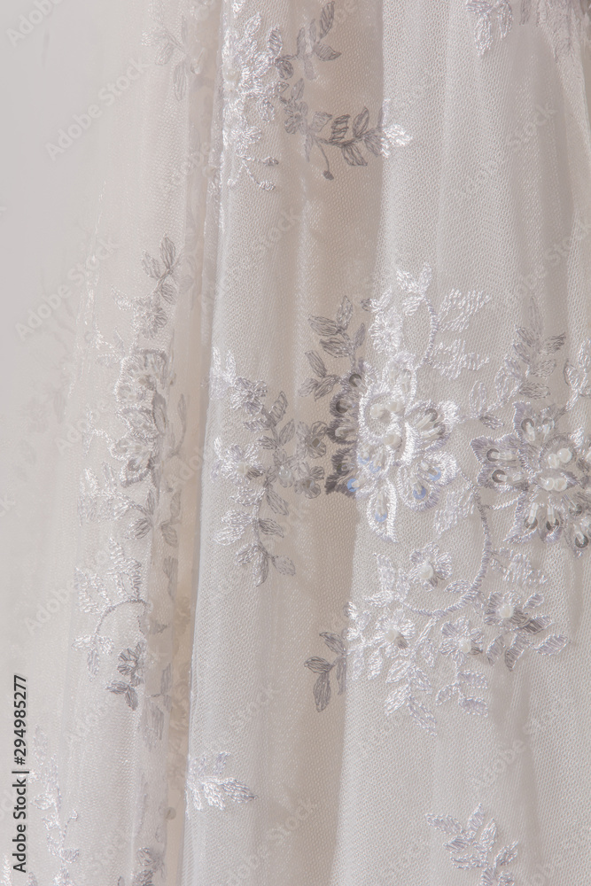 Details of the bride dress fabric and beautiful embroidery wedding concept used as a background for illustrations