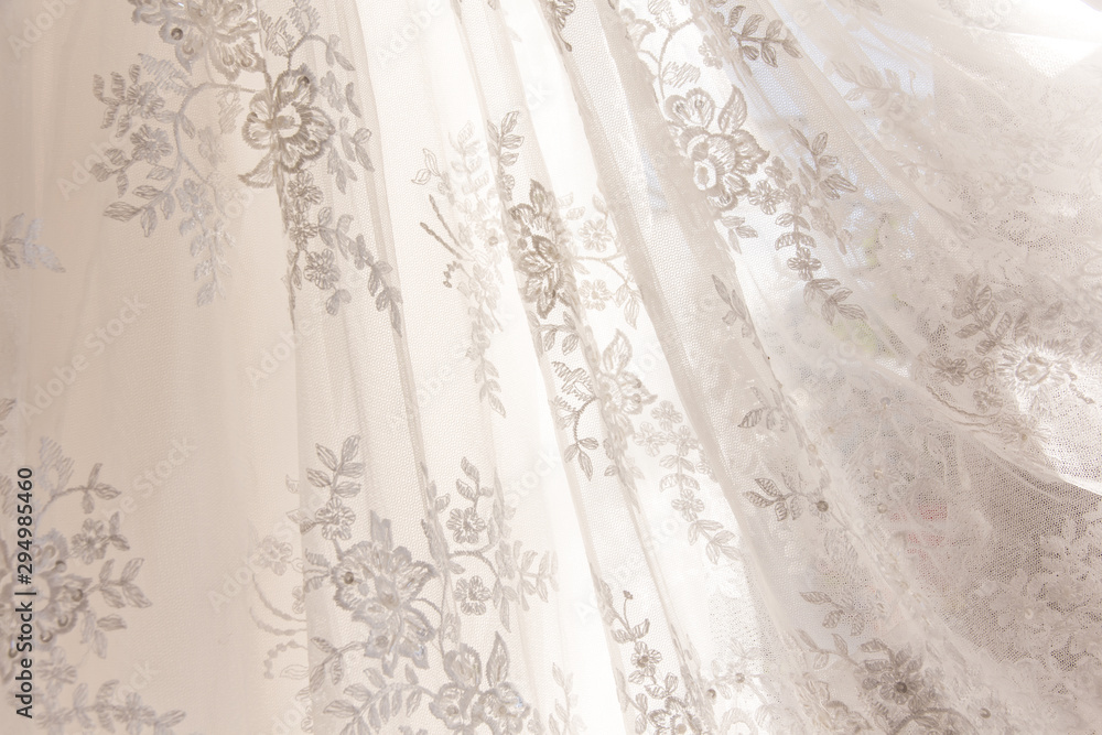 Obraz premium Details of the bride dress fabric and beautiful embroidery wedding concept used as a background for illustrations