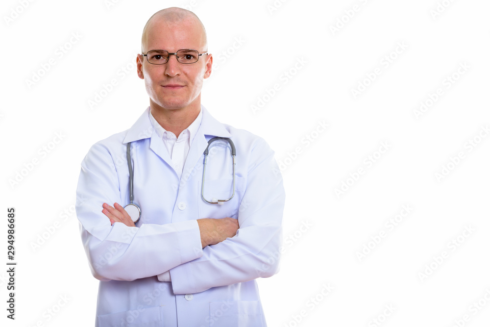 Studio shot of young handsome bald man doctor wearing eyeglasses Studio shot of young handsome bald man doctor wearing eyeglasses