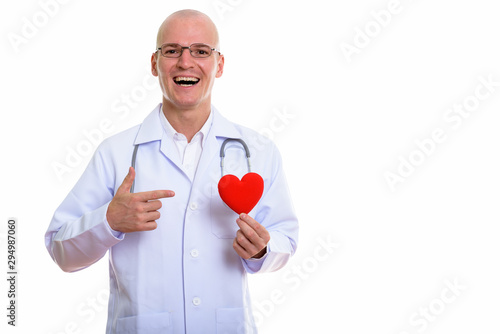 Young happy bald man doctor smiling while holding and pointing a © Ranta Images