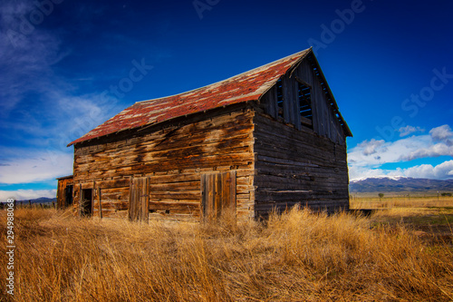 old barn with blue sky and clouds