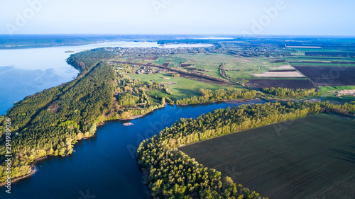 Flying over the beautiful spring river. Aerial camera shot. Ukraine.
