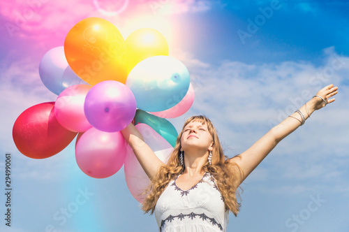 Happy young lady celebrates birthday with balloons
