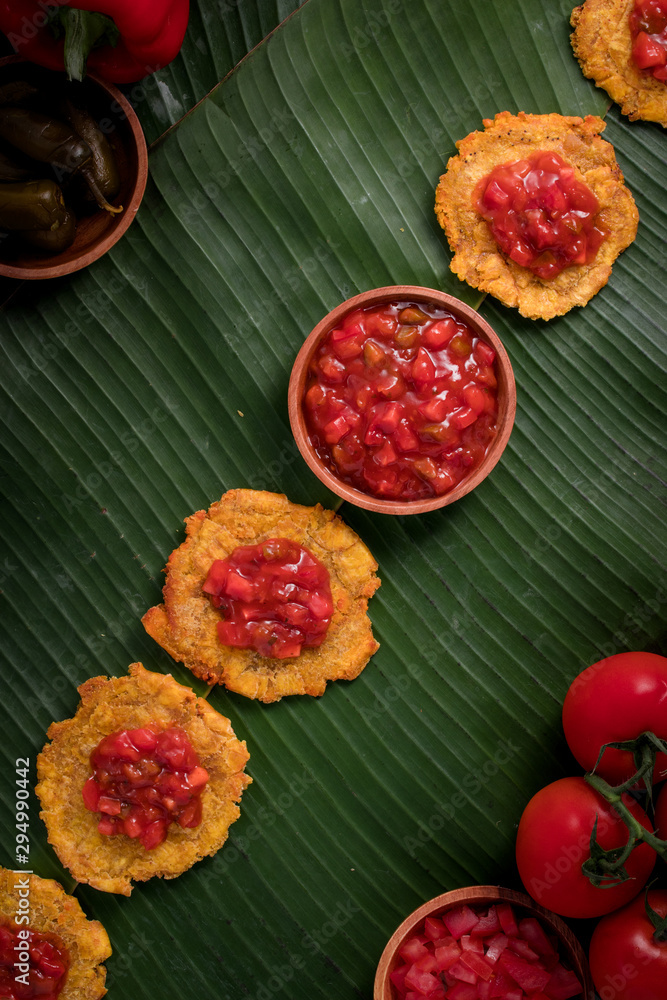 Banana Fritters with Tomato Chutney on top (also known as Patacones in Spanish, famous in Colombia) Post-Production: Rustic feel