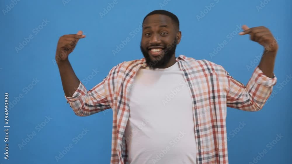 i'm the best! Excited overjoyed lucky black man feeling winner screaming with joy looking at camera isolated on blue studio background, african guy celebrating win triumph rejoicing victory motivated i'm the best! Excited overjoyed lucky black man feeling winner screaming with joy looking at camera isolated on blue studio background, african guy celebrating win triumph rejoicing victory motivated