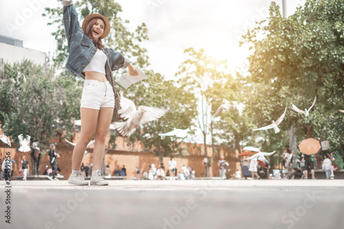Smiling woman traveler in thapae gate landmark chiangmai thailand enjoy and arms raised with backpack on holiday, relaxation concept, travel concept