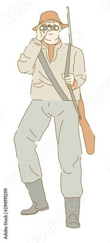 Hunter armed with rifle looking into binoculars