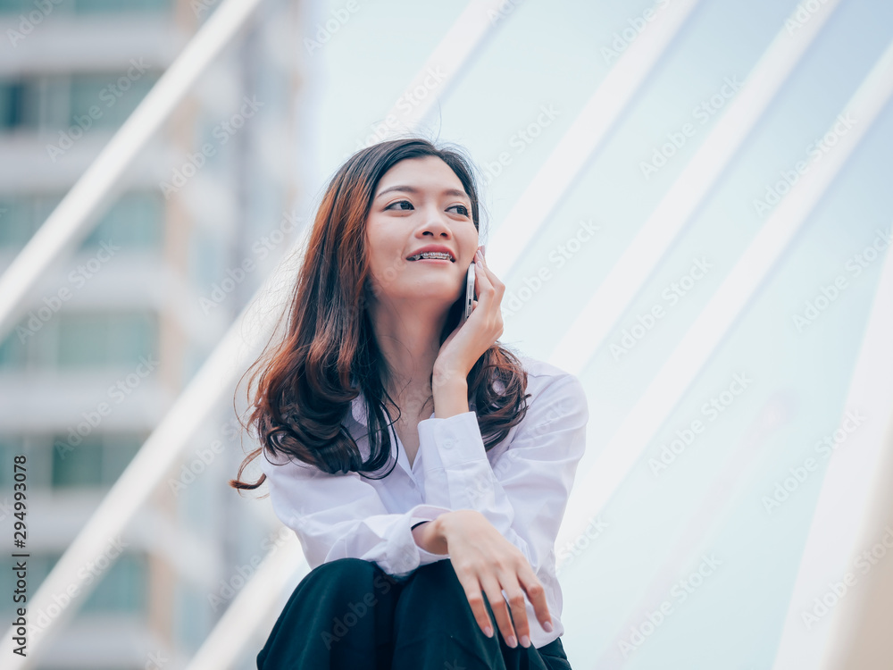 Fototapeta premium Asian young business woman with mobile phone
