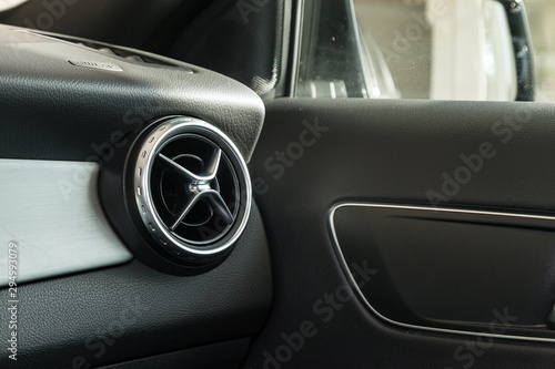 View to the black interior of car with dashboard, ventilation ducts, door and chrome after cleaning before sale on parking © Aleksandr Kondratov