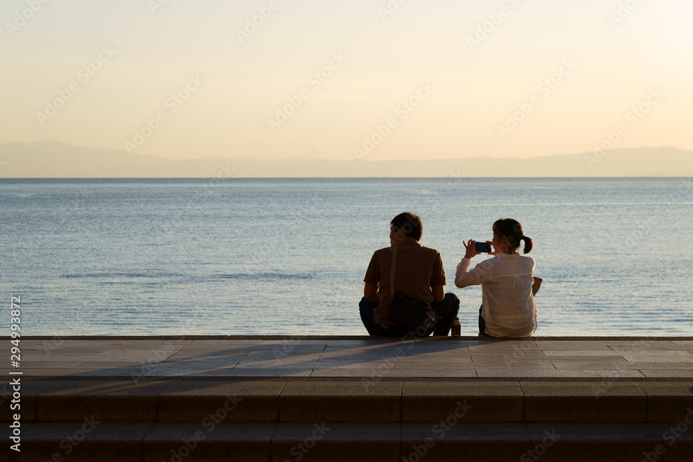 Couple speaking at the seaside in the evening