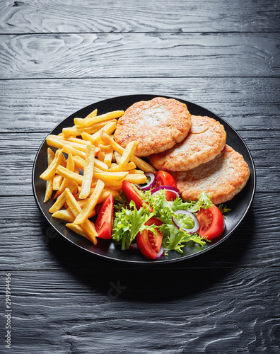 fried turkey burgers served with fries and salad