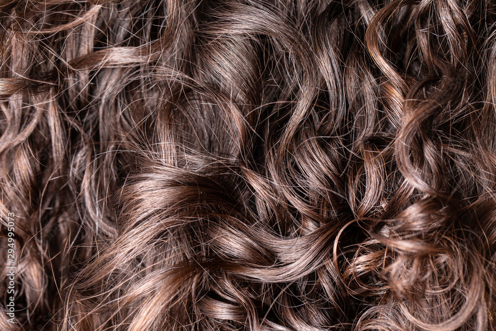 Close up view of woman's curly brown hair Close up view of woman's curly brown hair