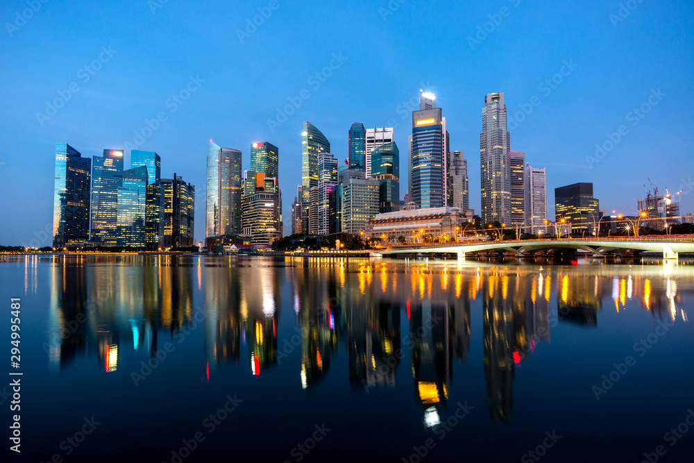 Beautiful Singapore cityscape at dusk. Landscape of Singapore business building around Marina bay. Modern high building in business district area at twilight and night.Effect Photo by long exposure.