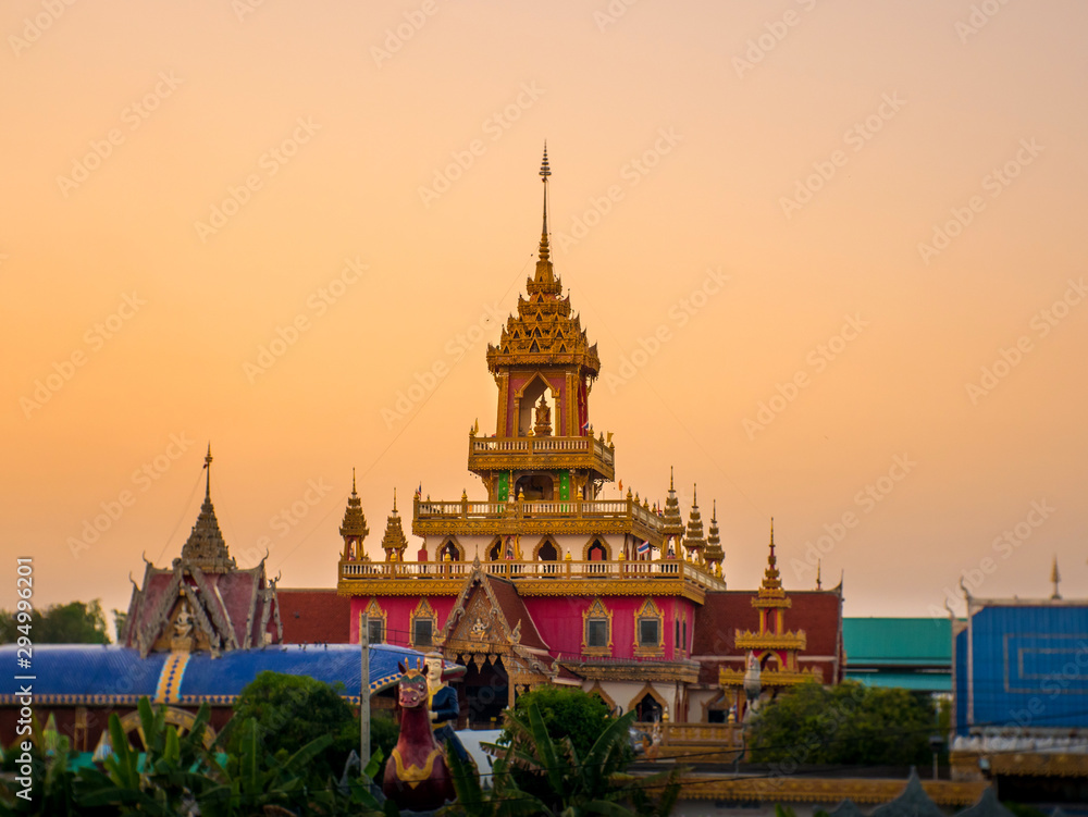 Fototapeta premium Sunset with Thai temple in Sisaket province,Thailand.