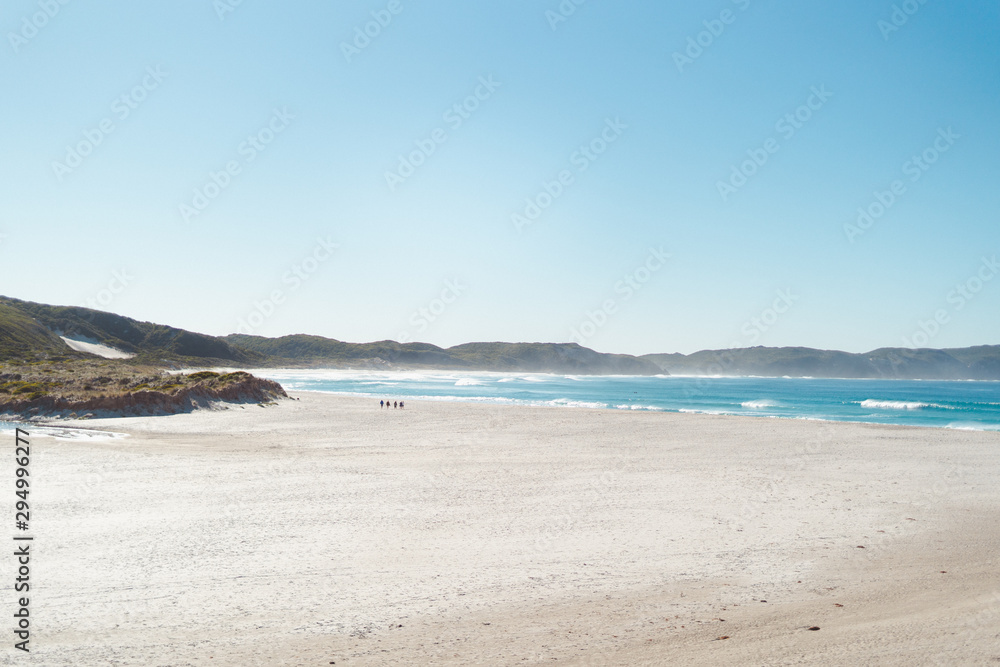 Beautiful white sand secluded, large beach in Albany with mountains as the background over the crisp blue ocean water.