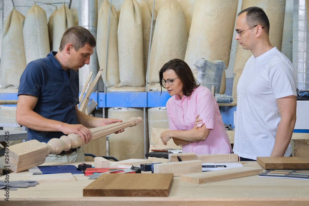 Obraz premium Industrial woodworking workshop, team of people discussing carpentry process