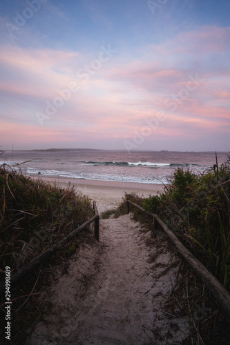 Epic pink and purple sunset over Cosy Corner Beach in Albany  Western Australia. Beautiful vibrant colours in the sky over the beach. 