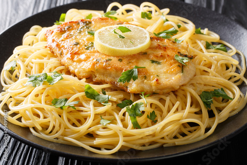 Konstfotografi Traditional chicken Francaise with spaghetti with lemon gravy close-up on a plate on the table