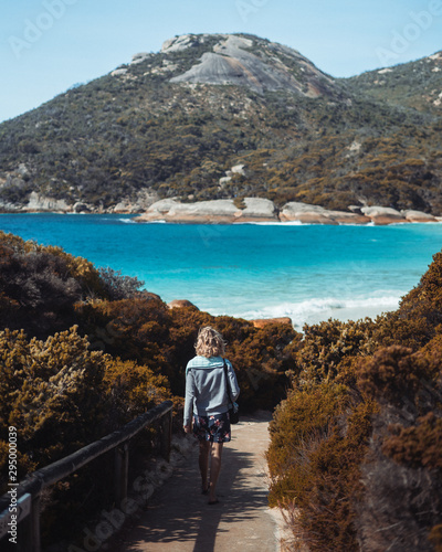 Young caucasian girl peacefully watching the waves crash on the shore of Little Beach. Located in Two Peoples Nature Reserve, Albany, Western Australia. 