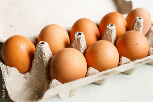 The brown eggs in egg box.