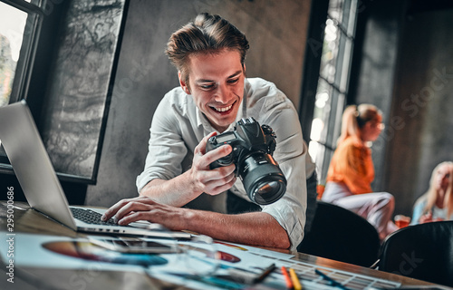Young cheerful photographer photo