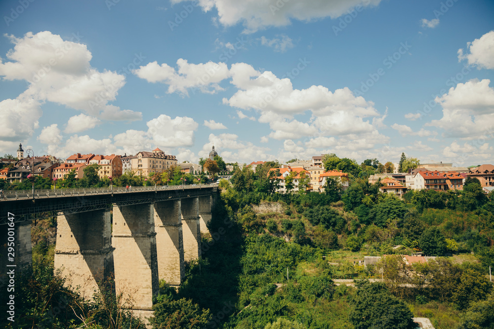 small European city landmark photography of stone bridge across canyon to old town touristic destination district in Ukraine 