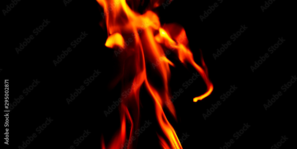 Fototapeta premium Fire texture isolated on black background. Fire flames on black background. Fire patterns. Texture of flames throughout the space. Red flames up close. The background with flames of fire..