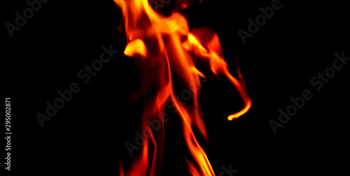 Fire texture isolated on black background. Fire flames on black background. Fire patterns. Texture of flames throughout the space. Red flames up close. The background with flames of fire..