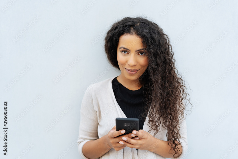 Thoughtful young woman scrutinising the camera Thoughtful young woman scrutinising the camera