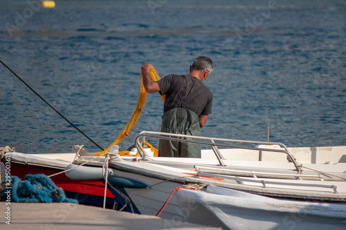 Fisherman preparing his fishing net on a fishing boat.