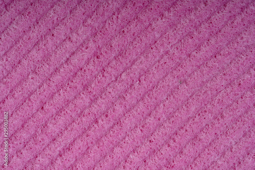 Household cleaning sponges closeup. Sponge detail texture, sponge texture close up background. Cellulose red sponge texture. Pink wire mesh on sponge surface background