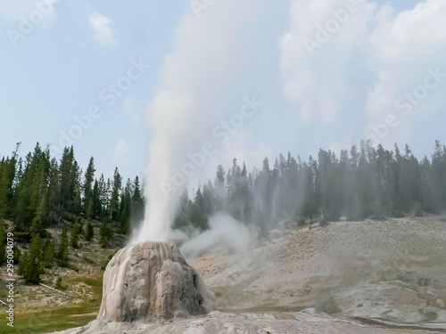 lone star geyser erupting in yellowstone park